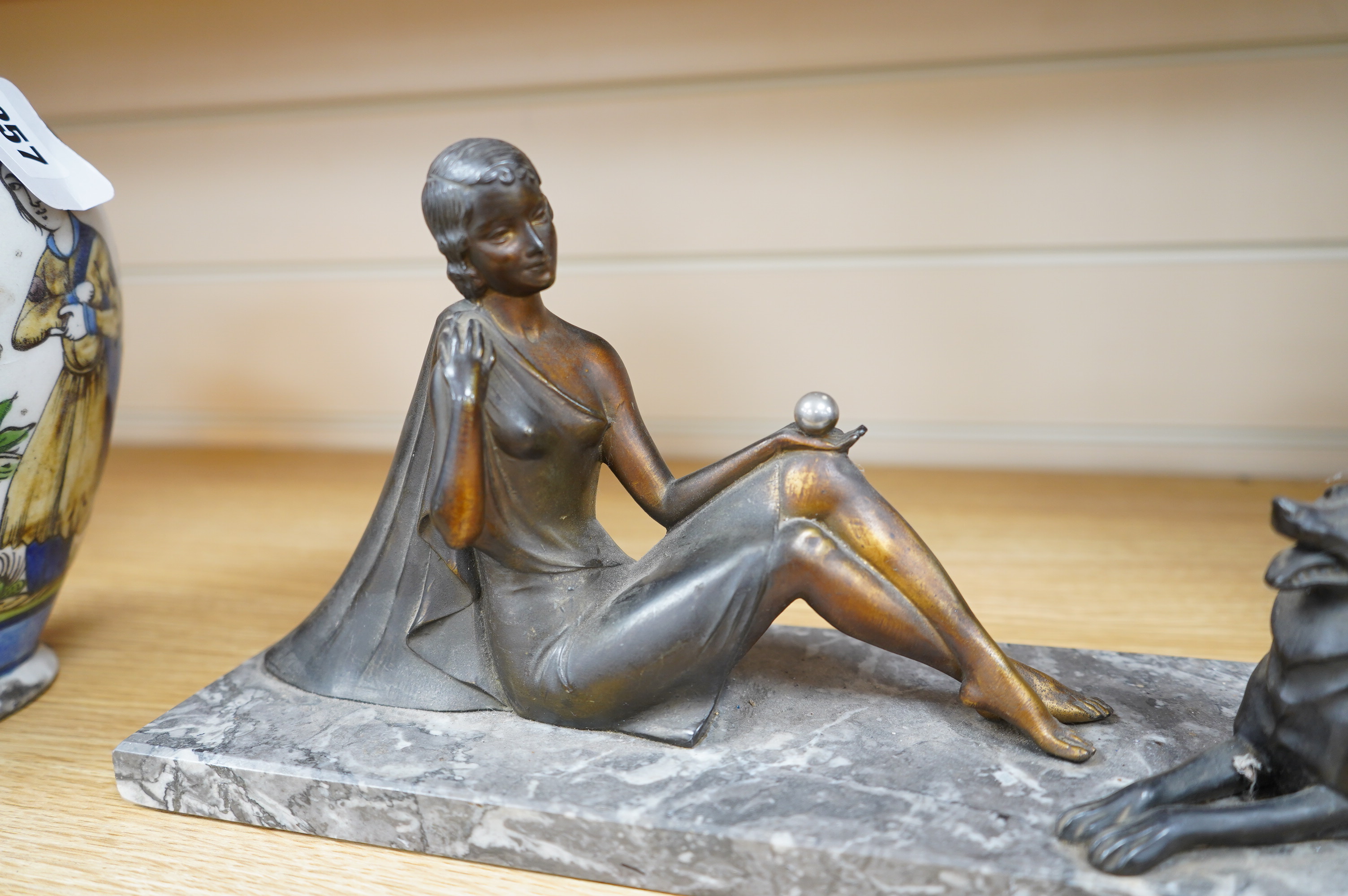 A French Art Deco spelter figure group, woman and dog, on marble base, signed H. BAL, 40cm long. Condition - fair to good